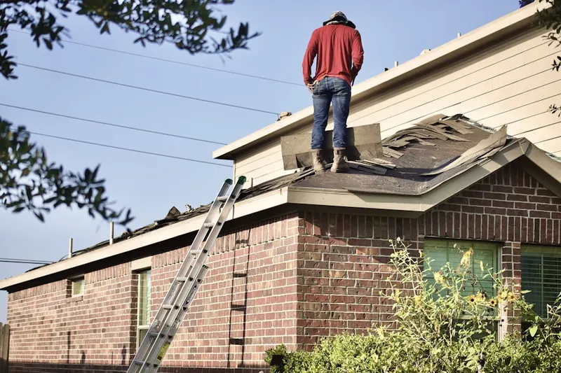 Professional roofer working on a residential roof in Huntingdon Valley